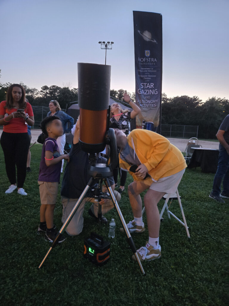 Young astronomer waits to look through telescope